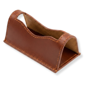 A brown leather desk card holder with smooth curved edges and visible stitching.