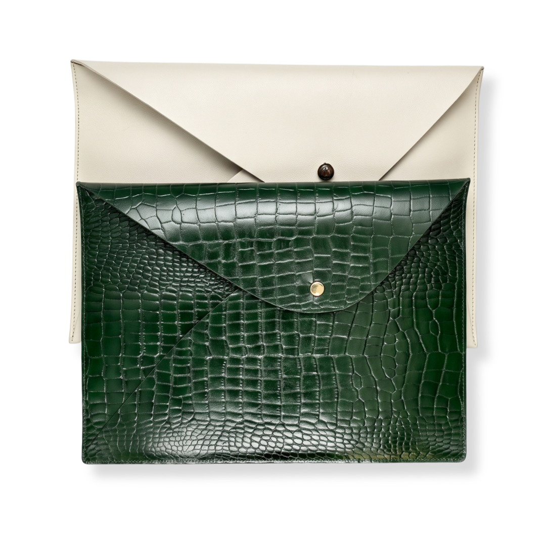 An A4-sized envelope clutch from The Leather Collection featuring a dark green and cream crocodile-embossed leather.